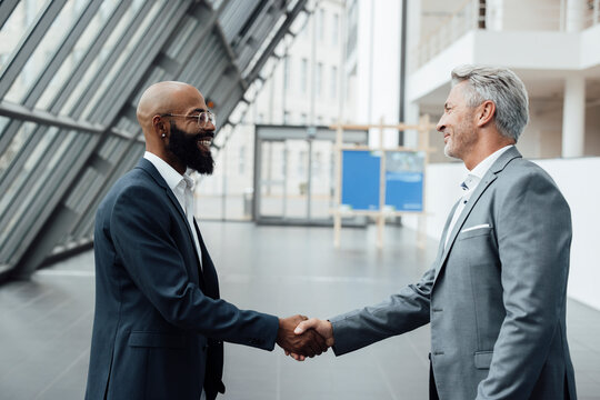 Business partners shake hands at a trade fair