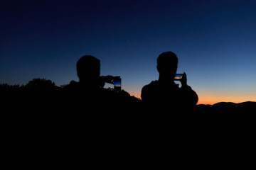 Amateur astronomers with smartphone photographing and observing stars, planets, Moon and other celestial objects. © astrosystem