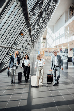 Business partners walk through a modern airport terminal