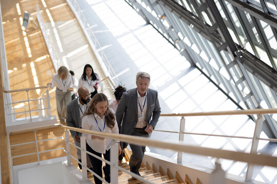 Colleagues climb a staircase at an international trade fair