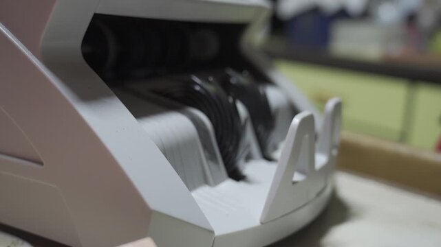 selective focus close up to Money counting machine in motion while bank note were counting action. Banking operation with money Business concept with money. Counting machine for money theme.