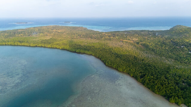 Aerial view of the lush mangrove forests and turquoise waters surrounding the Karimunjawa islands in Jepara Regency, Central Java, Indonesia.