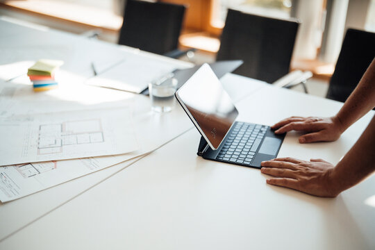 Male architect working on digital tablet at desk