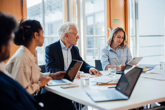 Business colleagues discuss a joint project at the office table