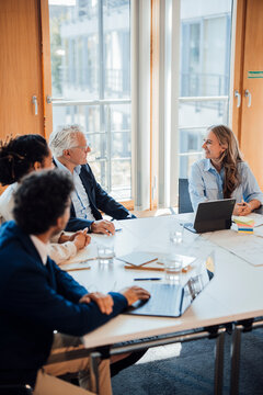 Colleagues discuss a joint project during a meeting at the office