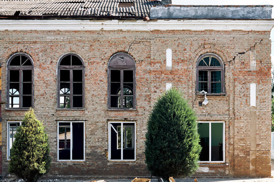 Damaged historic brick building facade after Russian drone attack in Ukraine city