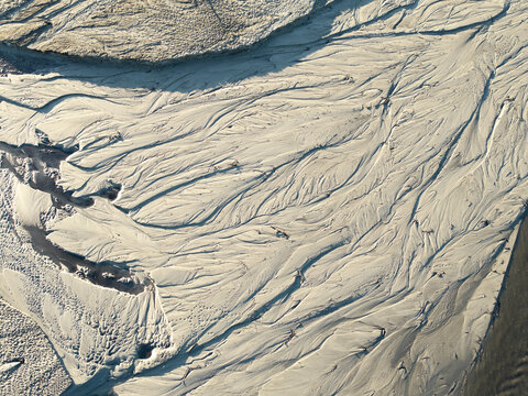 Aerial view of intricate sand and silt patterns forming natural abstract textures in a riverbed in Krakow, Lesser Poland Voivode, Poland.