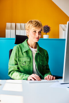 A confident businesswoman works on her computer at the office