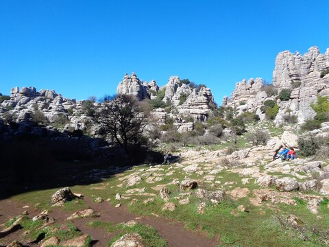 Hikers exploring the limestone rock formations of El Torcal de Antequera, M&aacute;laga, Spain.