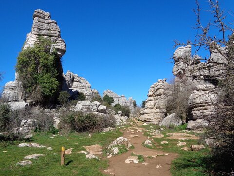Hiking trail through dramatic limestone formations in El Torcal de Antequera, M&aacute;laga, Spain.