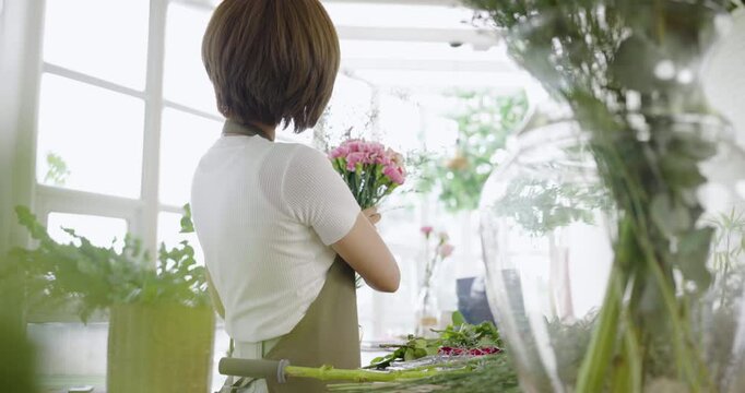 Startup successful sme small business entrepreneur owner asian woman standing table with flowers at florist shop service job. Portrait of asian girl successful owner environment friendly