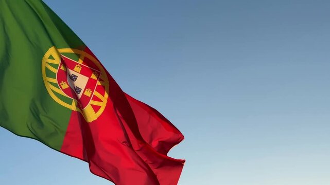 National flag of Portugal on wavy cloth. Features vertical green and red panels with the armillary sphere and shield. Professional top-down view for national holidays and news.