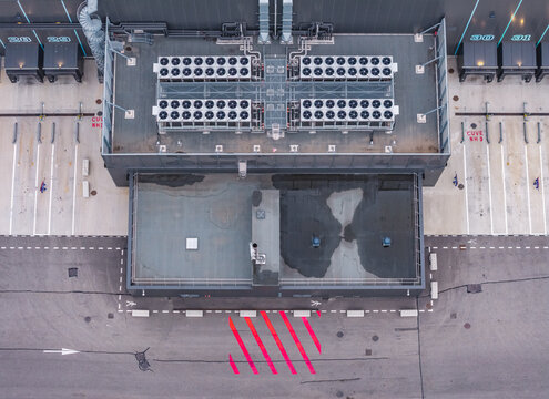 Aerial view of industrial rooftop cooling units and loading dock infrastructure at a modern warehouse and logistics distribution center in France.