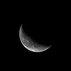 Paris, France - 10 05 2025: Detail view of the waning crescent moon by night from the city © Franck Legros