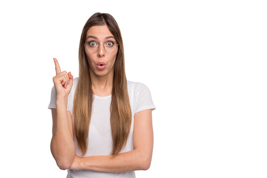 Photo of pretty lady nave awesome idea hold index finger raised wear specs and t-shirt isolated white background