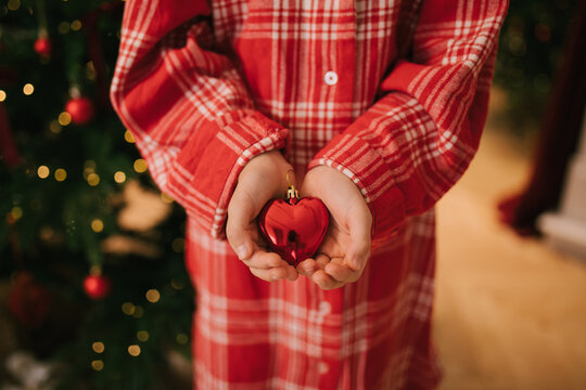 Cute 7-years old girl decorating Christmas tree