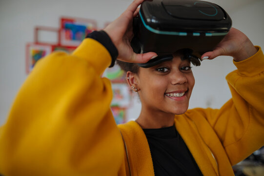High school student using virtual reality for immersive learning in classroom.