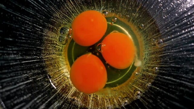 Omlet on a pan at home. Cooking in the kitchen cracked an egg and put it in the bowl and stirred it with fork and ready to cook the egg Omelette. 