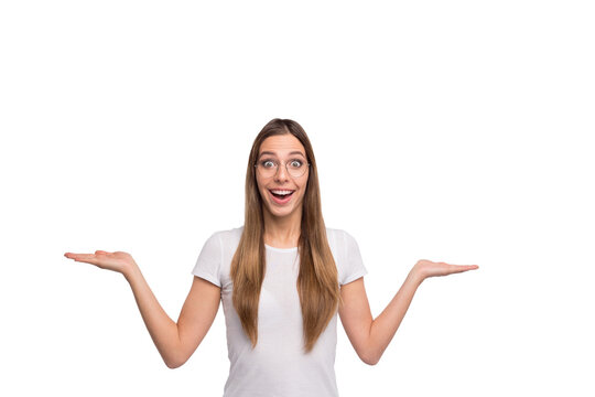 Beautiful lady holding new products on open palms pick best one wear specs and t-shirt isolated white background