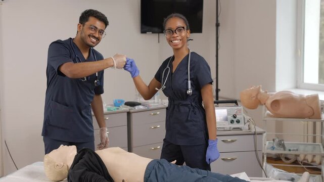 Medical students fist bumping after a successful cpr training