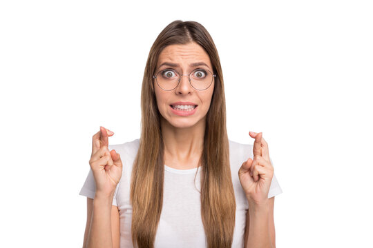 Photo of lady holding fingers crossed before final examination wear specs and casual t-shirt isolated white background