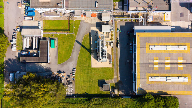 Aerial view of the Centro di distribuzione Esselunga di Liscate featuring large industrial rooftops, green lawns, and technical equipment in Liscate, Lombardia, Italy.
