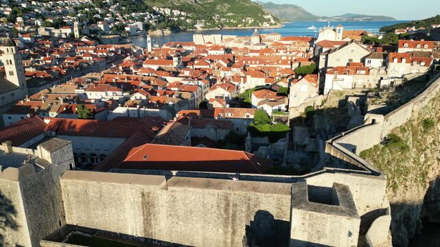 Historic Stone City Walls - Minceta Tower Above Dense Red Tile Roofs In Dubrovnik Old Town, Croatia. - aerial shot