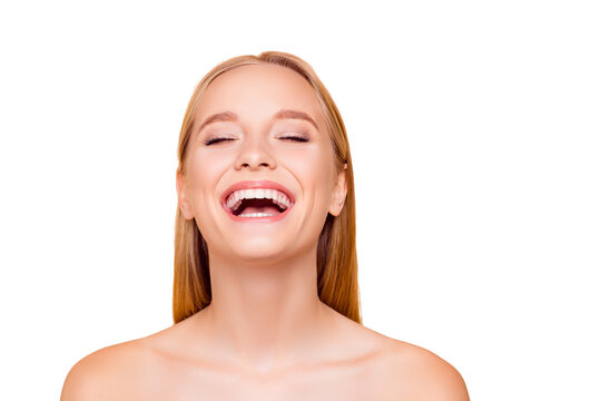 Positive, cheerful, funny, comic, fresh laughing natural nude girl with white teeth fresh cavity smooth soft skin laughing sincerely with close eyes isolated on beige background, perfection concept