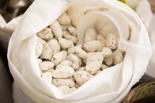 White chuno or black chuno in sack. Stocks of chuno, frost-treated or fermented wild potato root vegetable, traditional latin American side garnish product