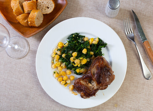 Appetizer or calorie-controlled diet lunch - baked piece of low-fat veal complemented with boiled chickpeas and spinach. ..