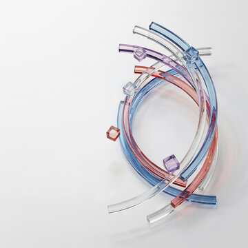 Abstract composition of colorful translucent glass tubes and small cubes on a white background with abstract translucent colorful artistic structure geometric minimalist sculpture reflection