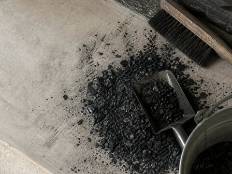 Creosote flakes and ash tools lie on hearth after chimney cleaning