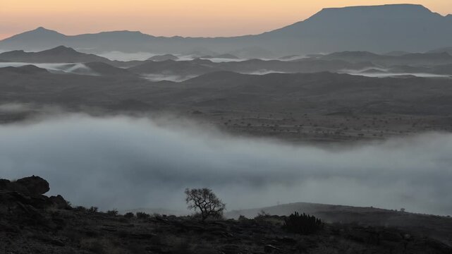 In the early morning, clouds drift over beautiful hills,  African landscape. Timelapse