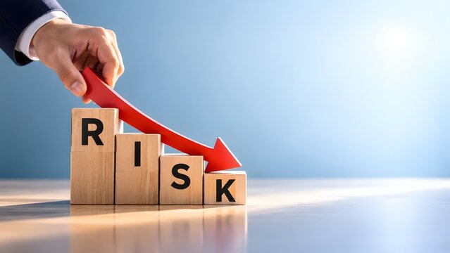 Businessman hand placing downward red arrow on risk wooden blocks representing financial crisis mitigation and investment safety