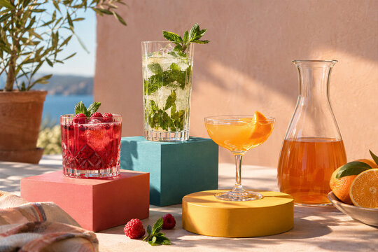 Raspberry, mint, and citrus drinks styled on a sunny coastal patio