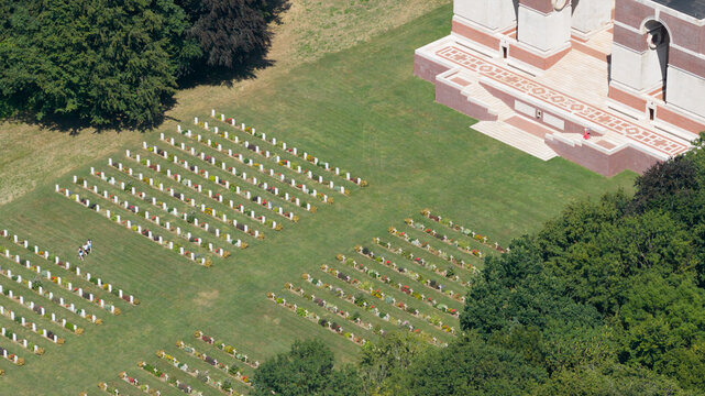 Aerial view of the Thiepval Memorial and the surrounding military cemetery with rows of white headstones set in green grass in Authuille, Hauts-de-France, France.