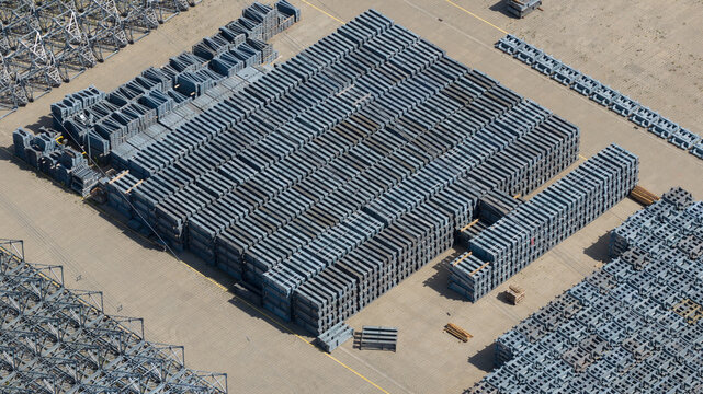 Aerial view of organized stacks of industrial metal beams and components stored in a large paved yard in Herne, North Rhine-Westphalia, Germany.