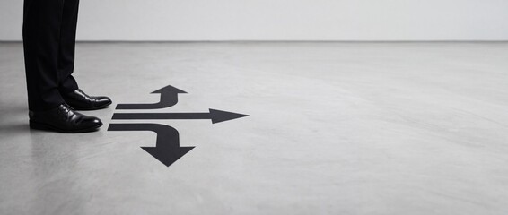 Fototapeta premium Businessman standing at a crossroads in front of three arrows pointing in different directions on a concrete floor, symbolizing decision making, career path choices, and business strategy options.