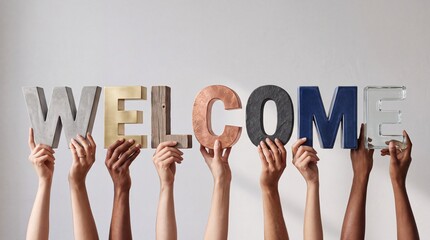 Fototapeta premium Diverse Group of People Holding Large Three Dimensional Letters Spelling Welcome Made of Various Materials Like Wood Metal Concrete and Glass Representing Inclusion Diversity and Hospitality