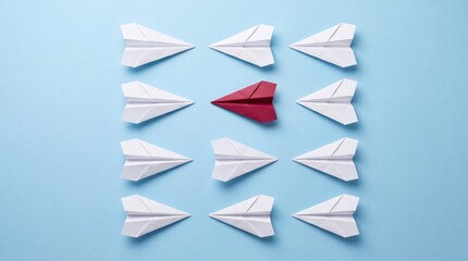 Fototapeta premium Top Down View of a Single Red Paper Plane Pointing One Direction While White Paper Airplanes Point Towards the Opposite Sides on a Light Blue Background, Concept of Leadership and Individuality
