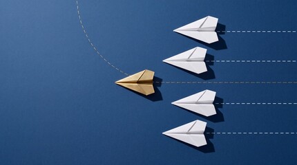 Fototapeta premium Gold paper plane changing direction and leading a group of white paper planes on blue background, metaphor for leadership, innovation, unique business strategy, and being different.