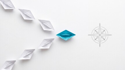 Fototapeta premium Top down overhead view of a blue paper boat leading a group of white paper boats towards a compass icon on a white background, representing leadership, guidance, business strategy and direction