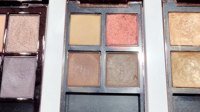Eyeshadow and Blush Palettes on Display in Cosmetics Store &ndash; Colorful Makeup Products on Shelf