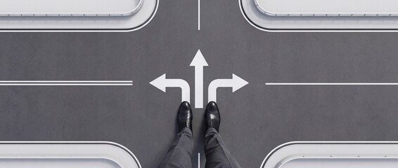 Fototapeta premium Businessman Standing at a Crossroad Faced with Three Directional Arrows on Asphalt Road, Concept of Career Choice, Strategic Decision Making, and Future Business Direction in Wide Context Format