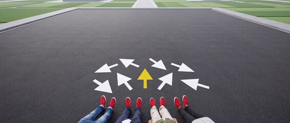 Fototapeta premium High Angle View of People in Red Shoes Sitting on Asphalt Road with Multiple Directional White Arrows and One Yellow Arrow Pointing Forward Symbolizing Decision Making, Leadership and Choice
