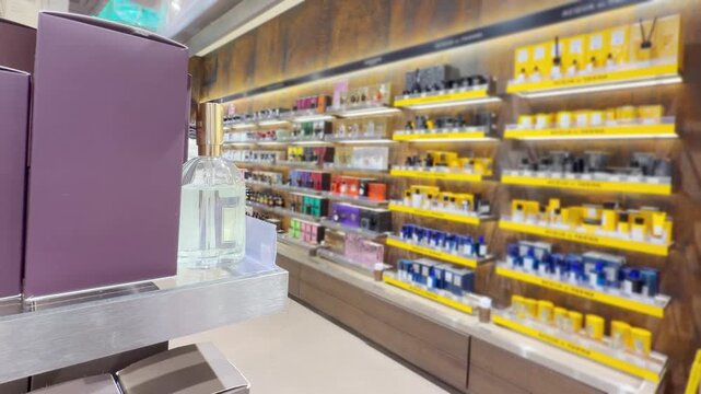 Perfume and Eau de Toilette Bottles on Display in Cosmetics Store &ndash; Fragrance Products on Shelf with Blurred Perfume Background
