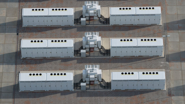 Aerial view of Tesla Megapack battery storage units arranged in rows at an industrial facility in Dronten, Flevoland, Netherlands.