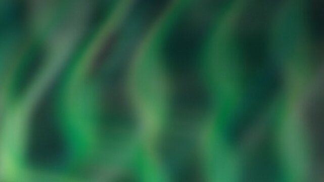Emerald and teal ribbons undulate across a dark field in a vivid organic animation, suggesting energy, nature, and renewal for wellness, technology, and creative backgrounds.