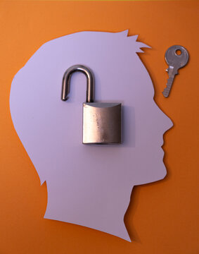 Silhouette of a human profile with an open padlock and a key to the side. It represents access, therapeutic recovery, open-mindedness, solving psychological problems, or overcoming barriers.