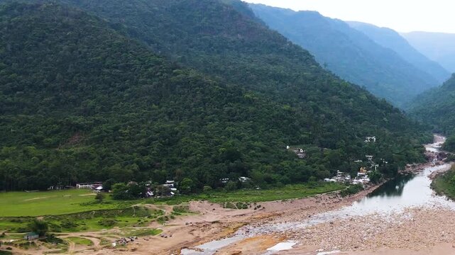 Aerial view of border hills, dry river channel and indigenous community in Sylhet Borderland - Aerial.